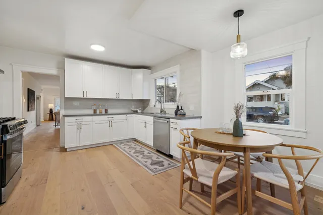 a kitchen with a table chairs stove and cabinets