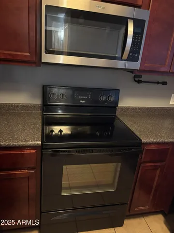 a stove top oven sitting inside of a kitchen
