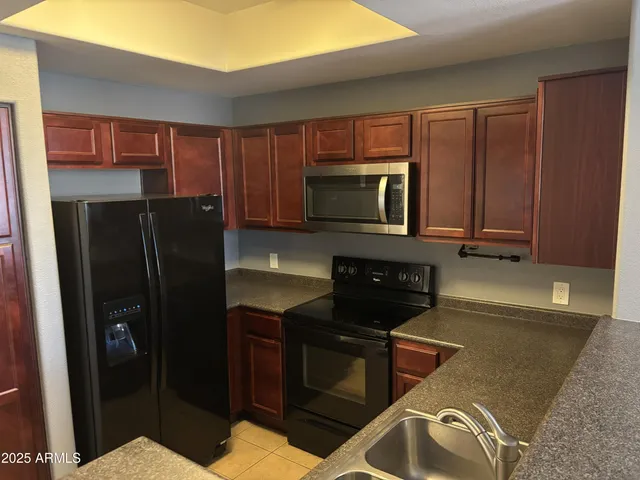 a kitchen with a refrigerator stove and cabinets