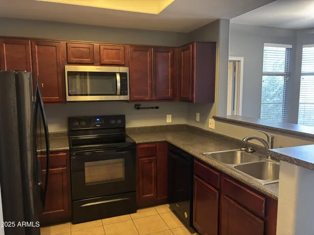 a kitchen with a sink stove and microwave