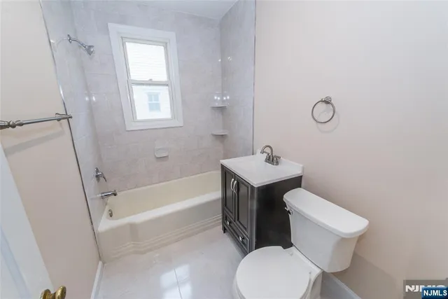 a white toilet sitting next to a bath tub