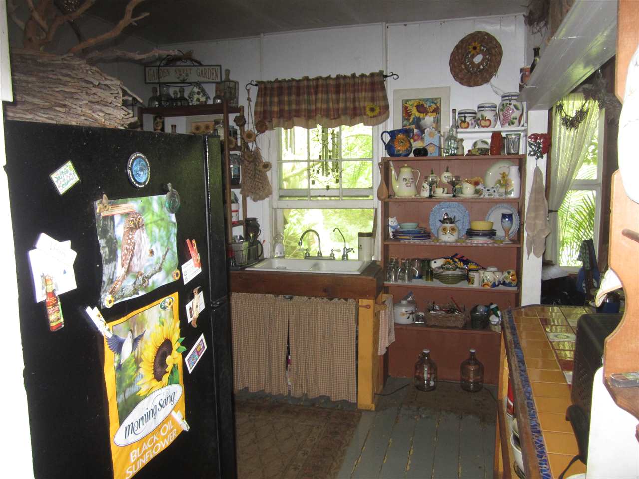 1085 West Kuiaha Road Haiku, HI 96708 - Photo 15 of 23 a kitchen with stainless steel appliances granite countertop a stove a refrigerator a sink and wooden floor