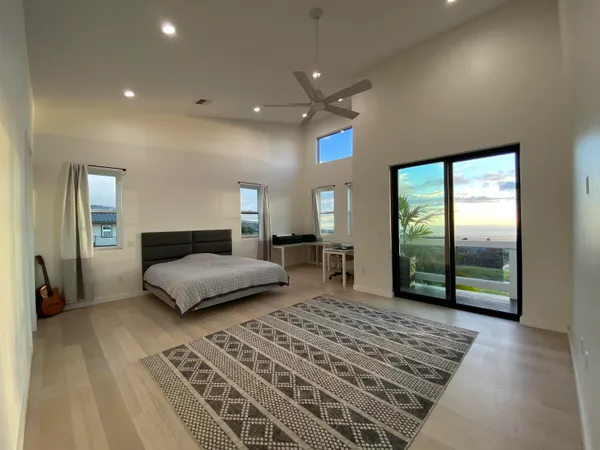 a bedroom with a large bed and a window