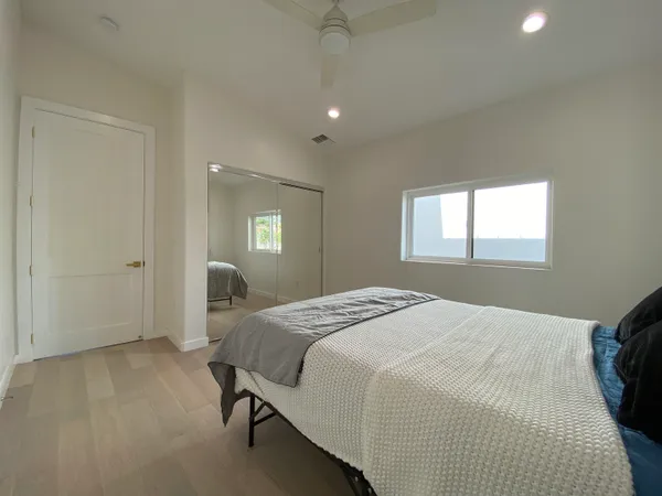 a bedroom with a bed and a mirror