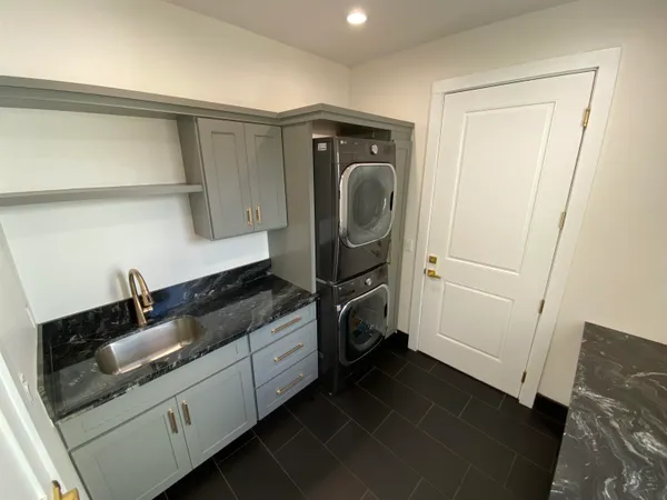 a utility room with sink dryer and washer