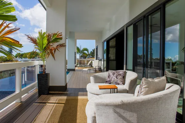 a living room with furniture and large windows
