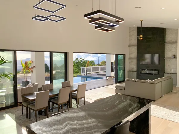 a view of a dining room with furniture a chandelier and wooden floor