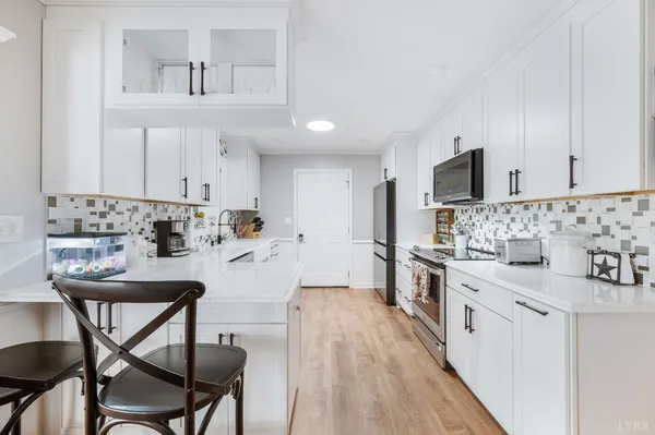 a kitchen with stainless steel appliances a stove sink microwave and cabinets