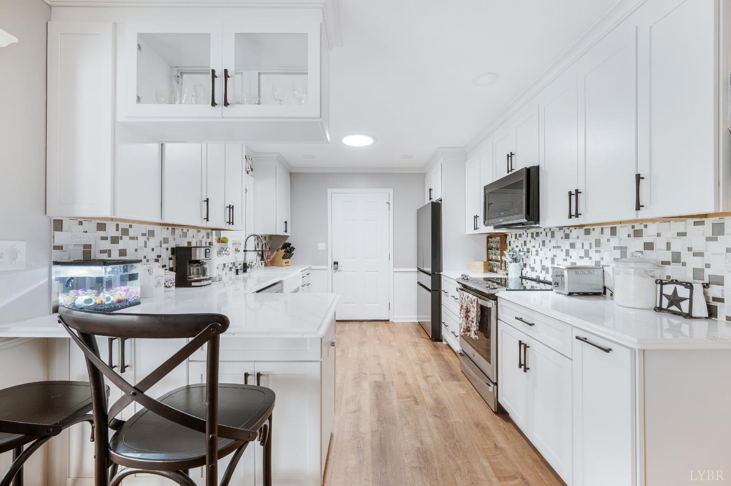 192 Liberty Chapel Road Appomattox, VA 24522 - Photo 12 of 60 a kitchen with stainless steel appliances kitchen island granite countertop a sink and cabinets