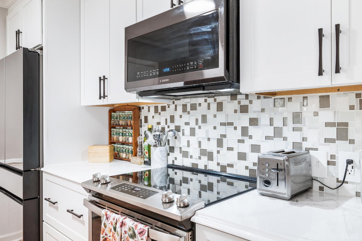 192 Liberty Chapel Road Appomattox, VA 24522 - Photo 14 of 60 a kitchen with a stove and a microwave