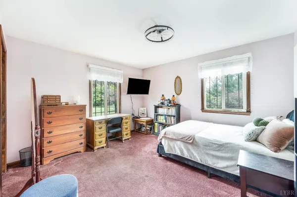 a bedroom with a bed and walk in closet with window