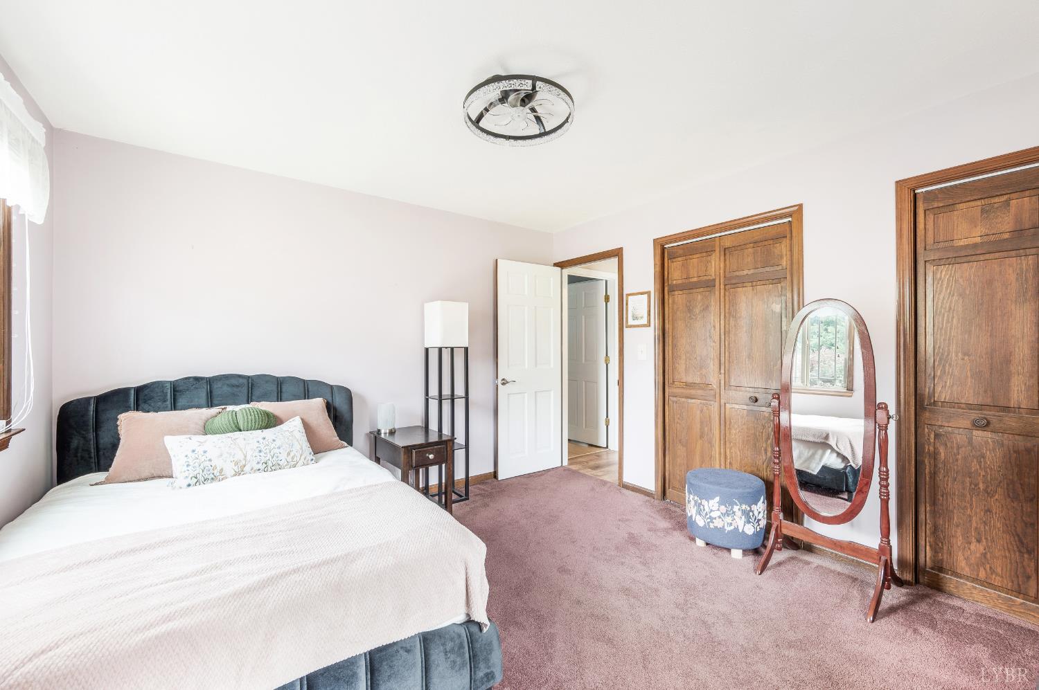 192 Liberty Chapel Road Appomattox, VA 24522 - Photo 26 of 60 a bedroom with a bed and a chandelier