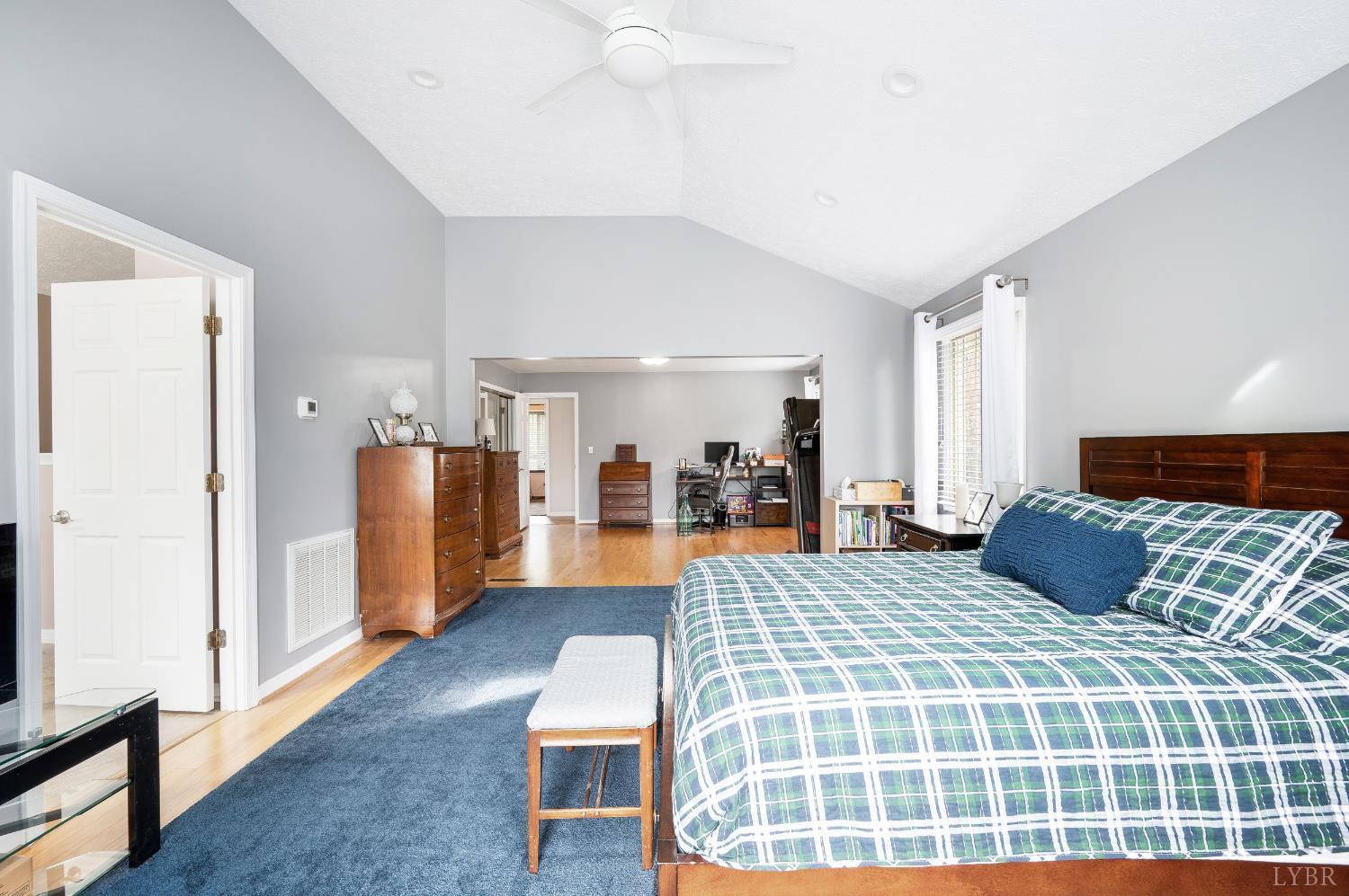 192 Liberty Chapel Road Appomattox, VA 24522 - Photo 29 of 60 a bedroom with a large bed and a chandelier