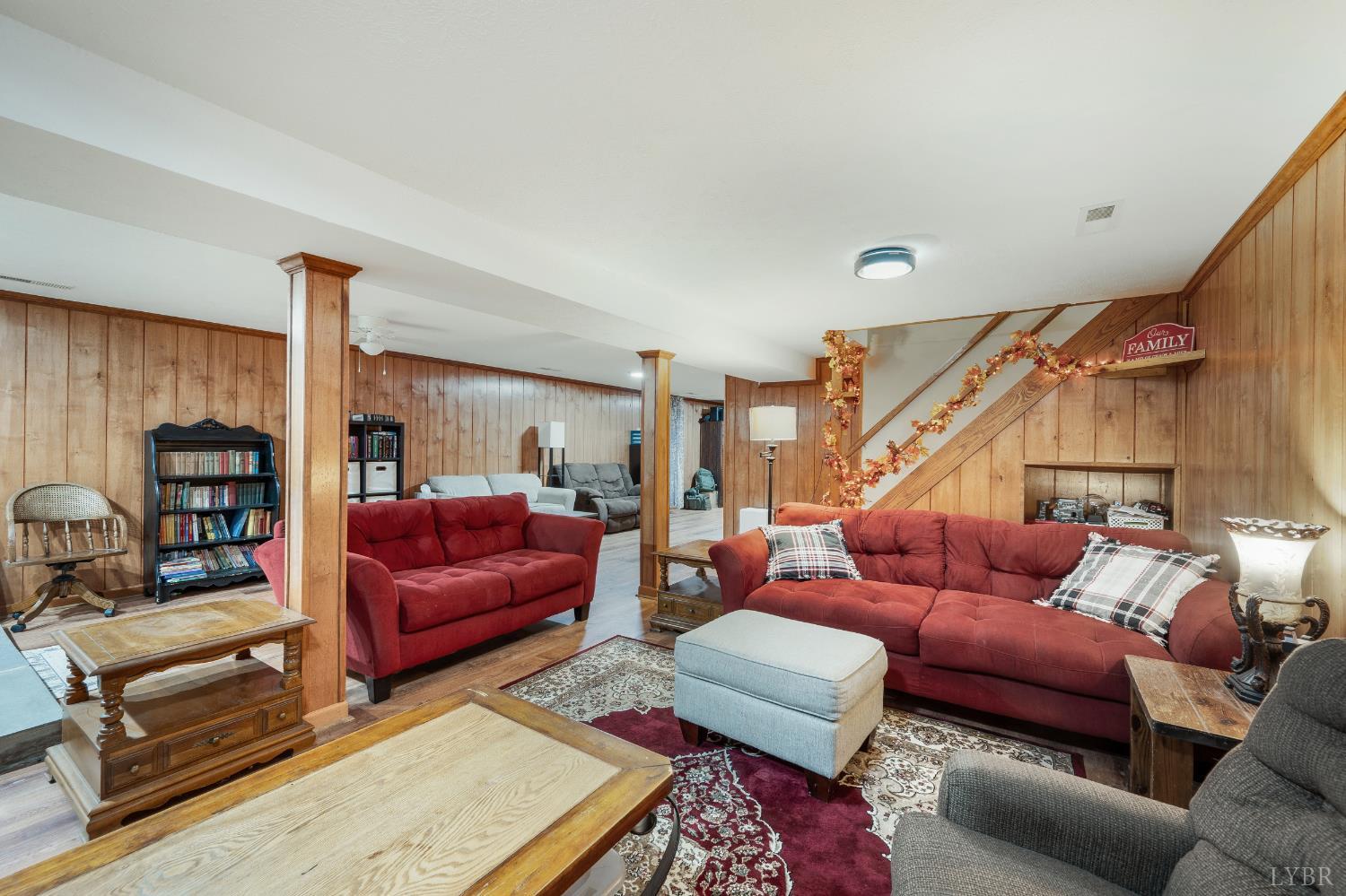 192 Liberty Chapel Road Appomattox, VA 24522 - Photo 41 of 60 a living room with furniture a red rug and a floor to ceiling window
