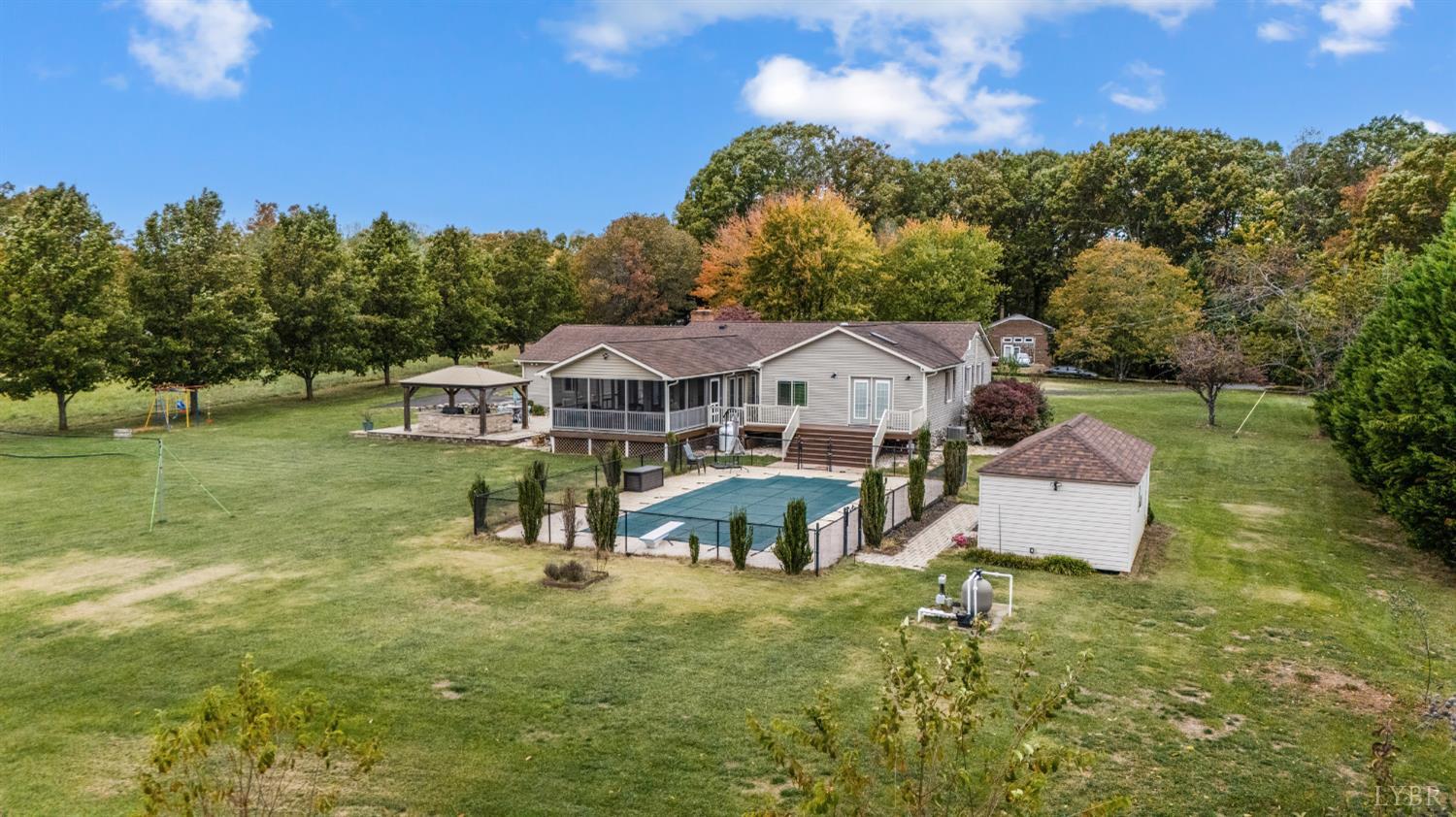 192 Liberty Chapel Road Appomattox, VA 24522 - Photo 6 of 60 an aerial view of a house with swimming pool and green space