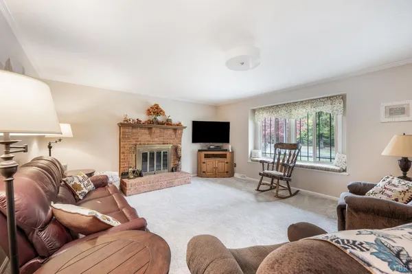 a living room with furniture window and a flat screen tv