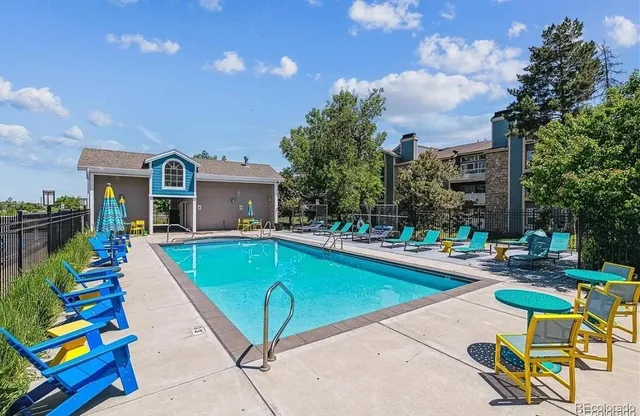 a view of a house with swimming pool and sitting area