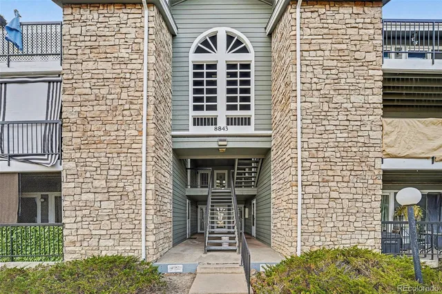 a front view of a house with large windows