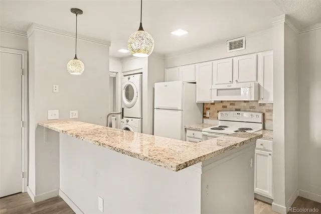 a kitchen with kitchen island granite countertop a sink a center island and stainless steel appliances