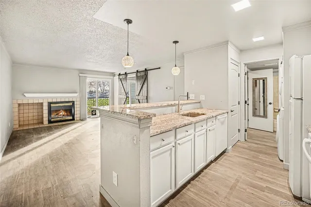 a spacious kitchen with a sink and a fireplace