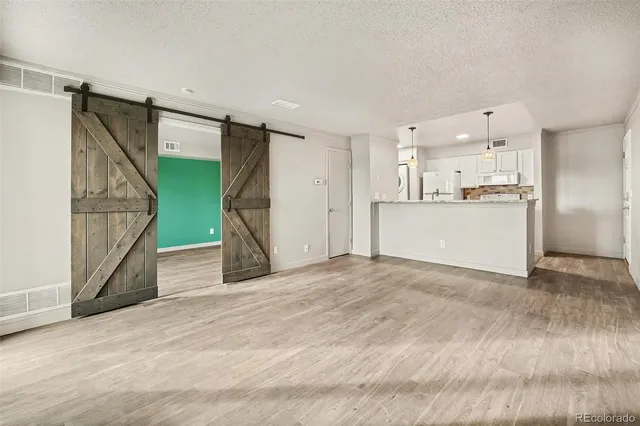 a view of a kitchen with a sink and a refrigerator