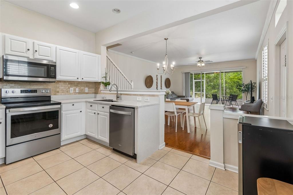 26527 Castleview Way Wesley Chapel, FL 33544 - Photo 11 of 45 a kitchen with a stove sink and stainless steel appliances