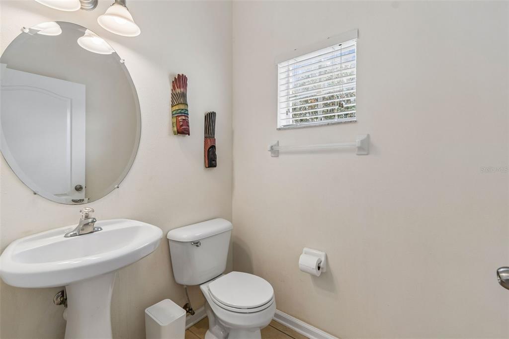 26527 Castleview Way Wesley Chapel, FL 33544 - Photo 15 of 45 a bathroom with a sink a mirror and a toilet