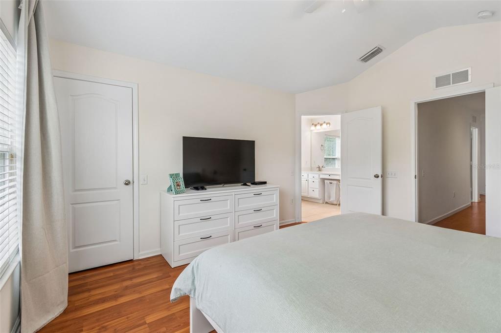 26527 Castleview Way Wesley Chapel, FL 33544 - Photo 17 of 45 a bedroom with a bed and a flat screen tv