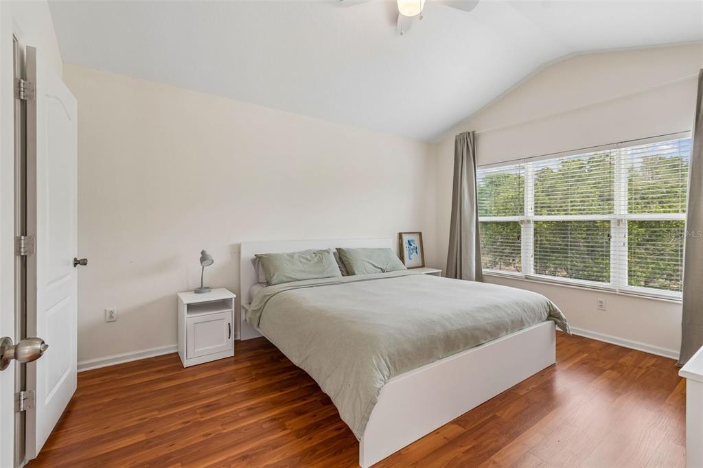 26527 Castleview Way Wesley Chapel, FL 33544 - Photo 18 of 45 a bedroom with a bed and a large window