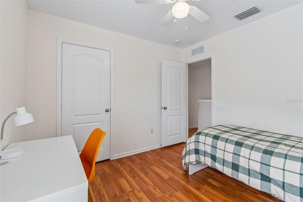 26527 Castleview Way Wesley Chapel, FL 33544 - Photo 20 of 45 a bedroom with a bed and a chandelier