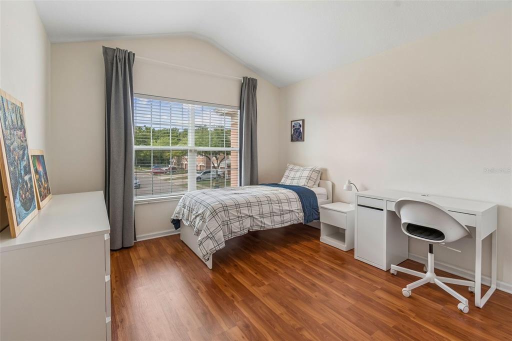 26527 Castleview Way Wesley Chapel, FL 33544 - Photo 22 of 45 a living room with a bed furniture and a large window