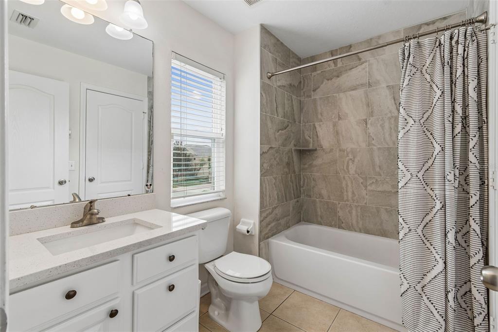 26527 Castleview Way Wesley Chapel, FL 33544 - Photo 28 of 45 a bathroom with a sink a toilet and a bathtub