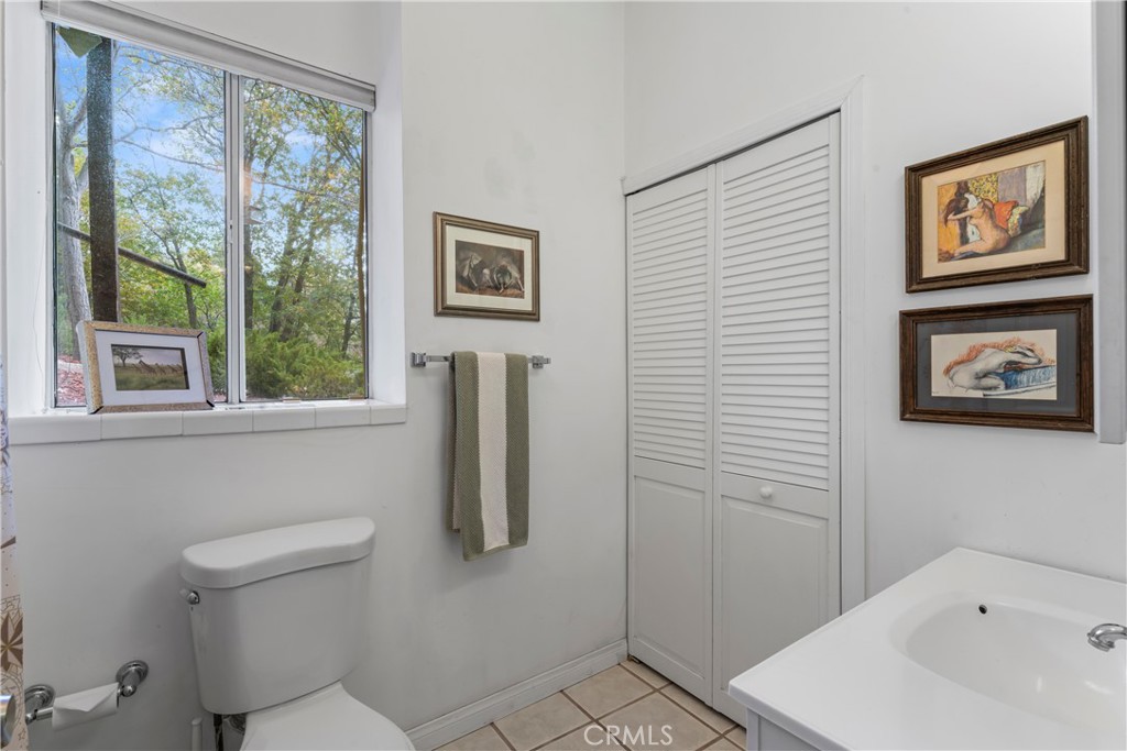 705 Cypress Road Cedar Glen, CA 92321 - Photo 26 of 51 a bathroom with a toilet a sink and a window
