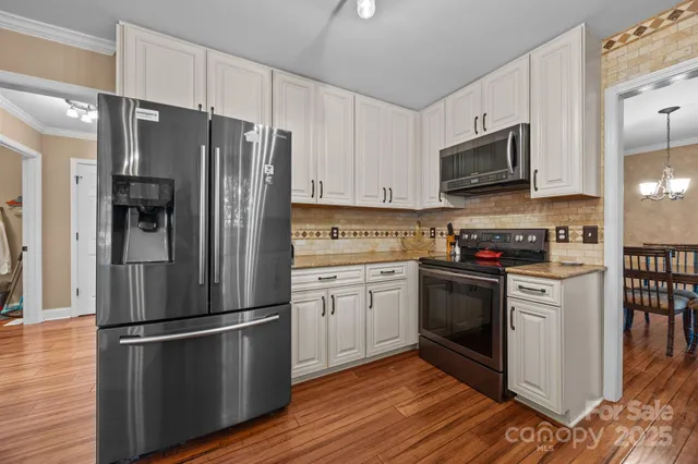 a kitchen with stainless steel appliances a refrigerator stove and microwave
