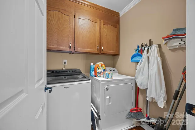a utility room with sink dryer and washer