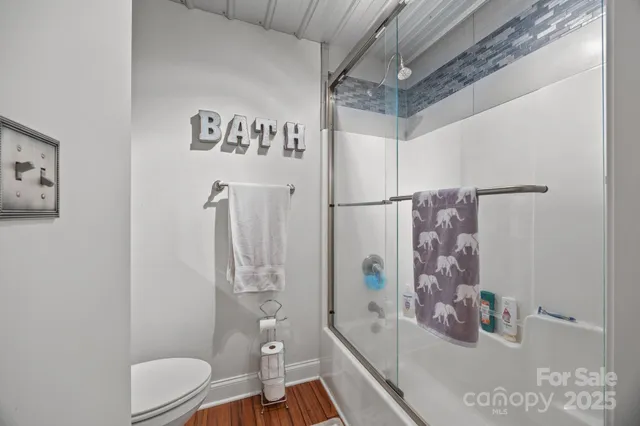 a bathroom with a toilet and shower