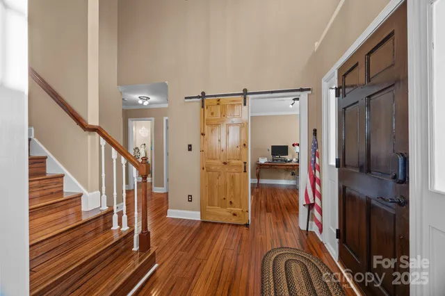 a view of a hallway view with wooden floor and staircase