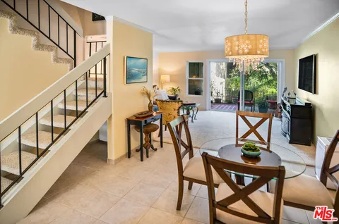 a view of a livingroom with furniture window and hardwood floor
