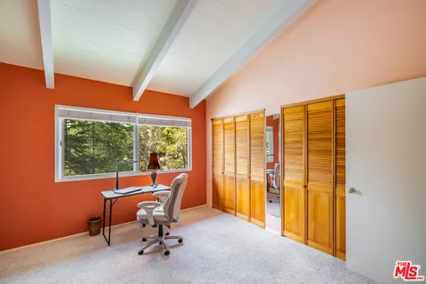 a view of a room with a large window and chair