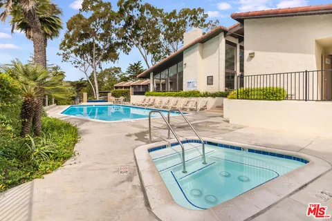 a view of a swimming pool with a lounge chairs