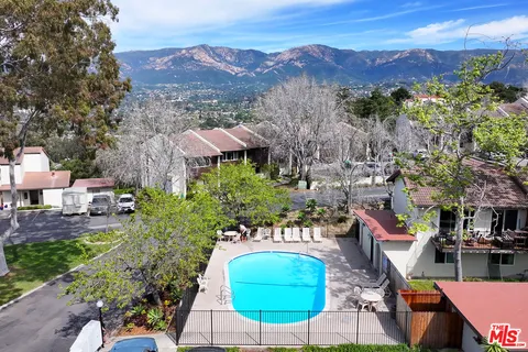 an aerial view of a house with yard and mountain view