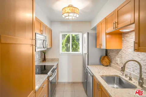 a kitchen that has a sink and a stove