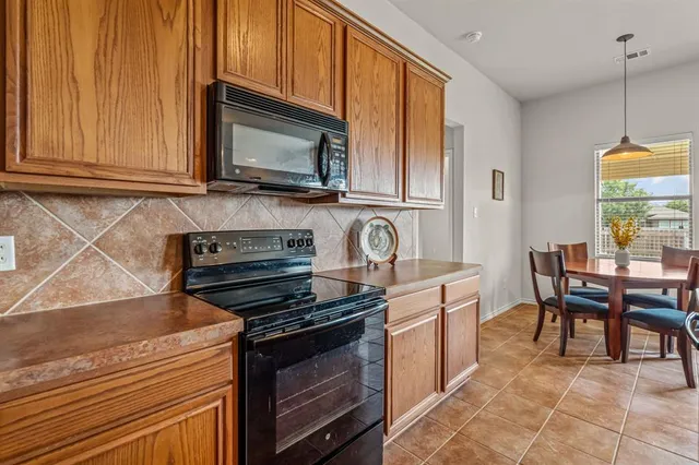 a kitchen with stainless steel appliances a stove a microwave and cabinets