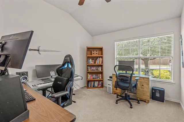 a view of a workspace with furniture and a window