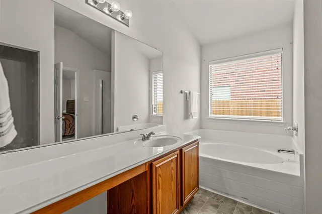 a bathroom with a bathtub and a sink