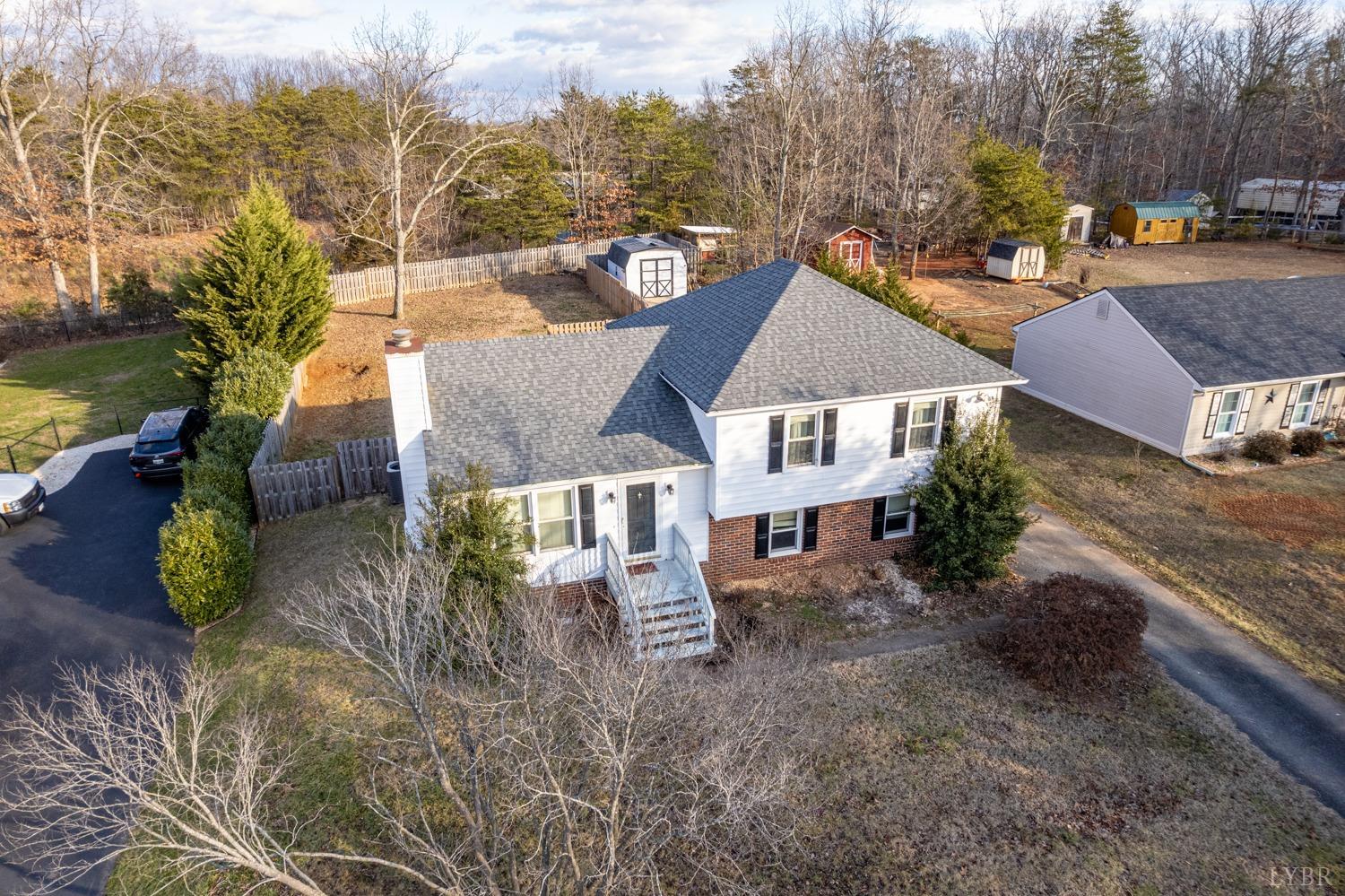 a view of a house with a yard and sitting area