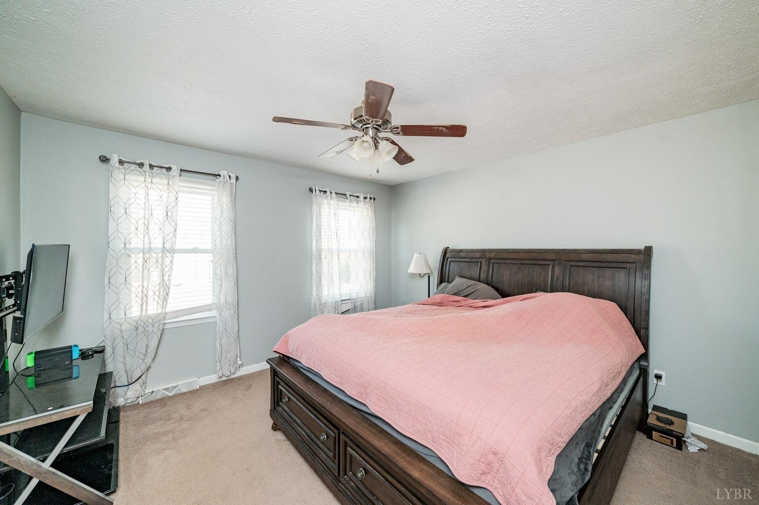 2271 Sunburst Road Evington, VA 24550 - Photo 13 of 26 a bed sitting in a bedroom next to a window