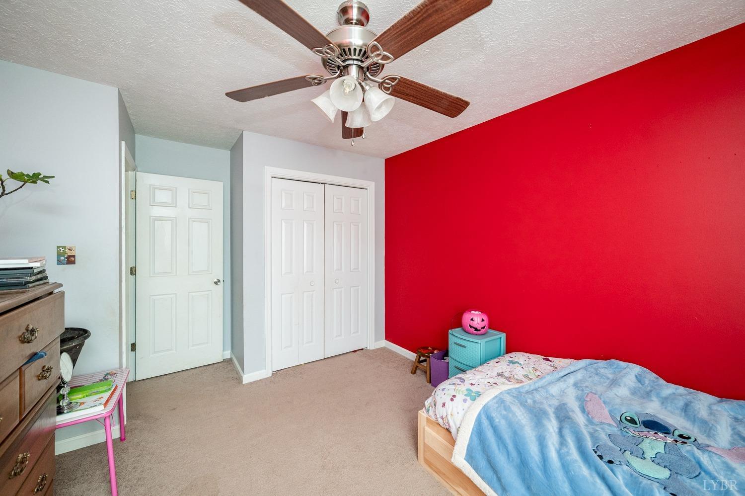 2271 Sunburst Road Evington, VA 24550 - Photo 16 of 26 a bedroom with a bed and a chandelier