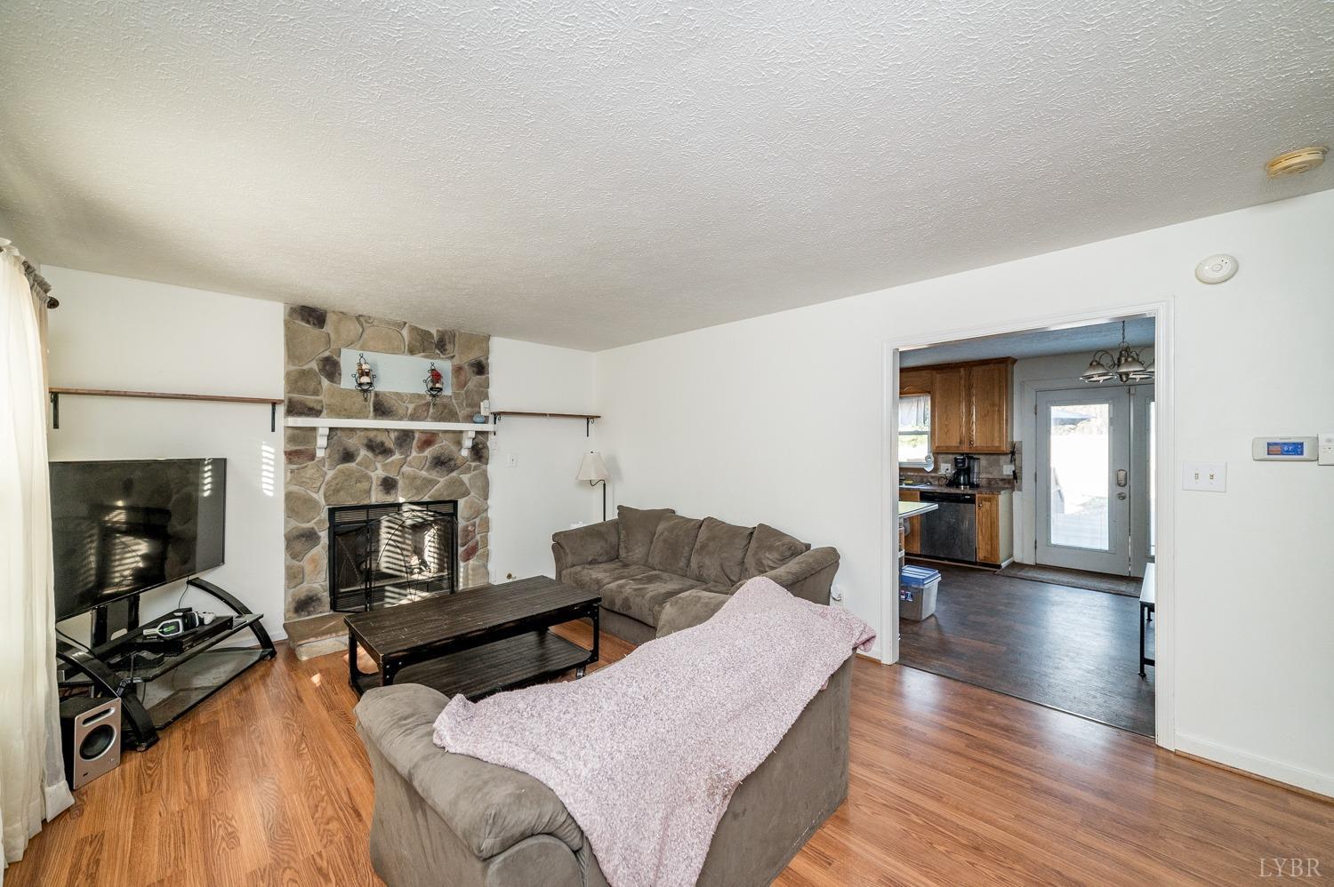 2271 Sunburst Road Evington, VA 24550 - Photo 2 of 26 a living room with furniture and a fireplace