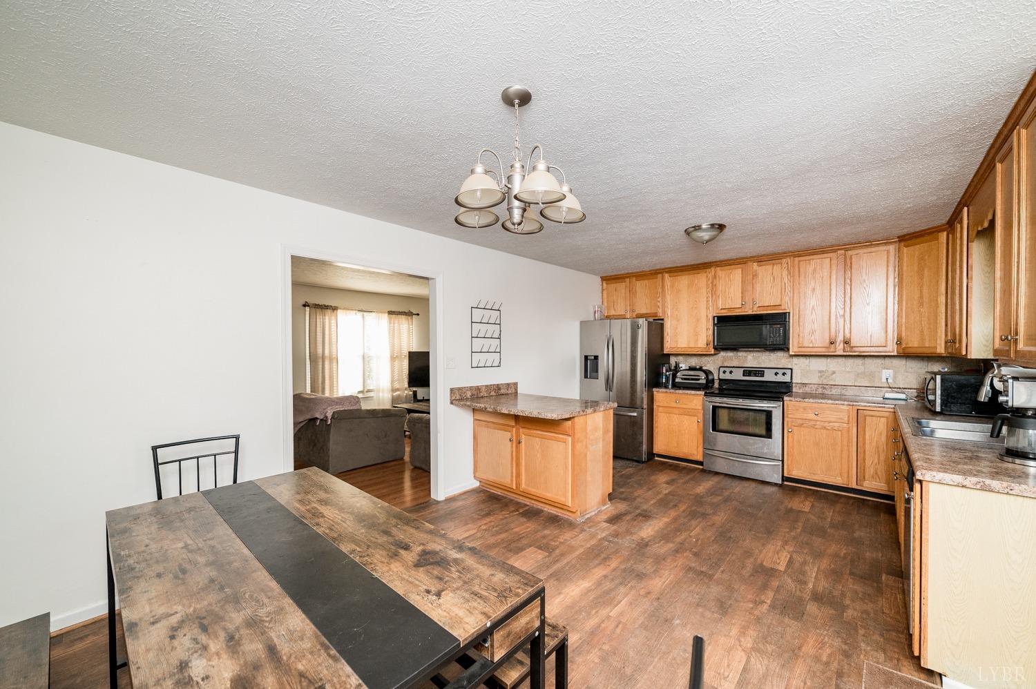 2271 Sunburst Road Evington, VA 24550 - Photo 9 of 26 a large kitchen with cabinets